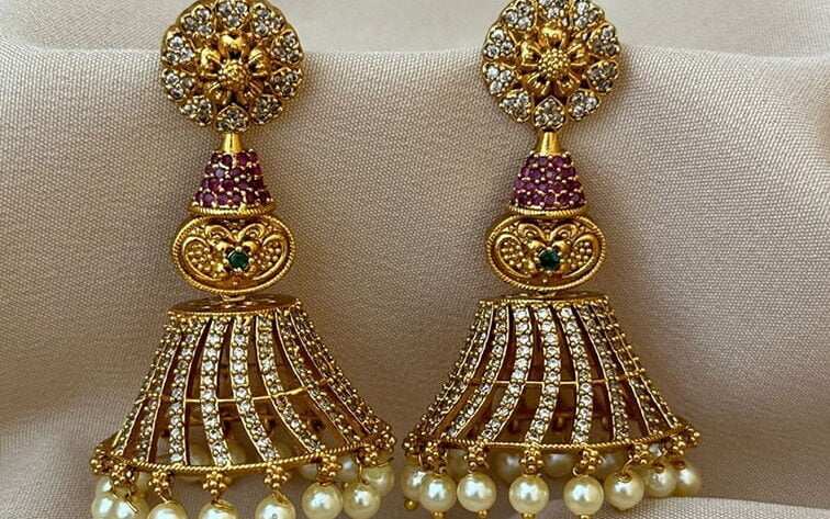 Elegent antique earrings adorned with gold plated jhumkas and pearls